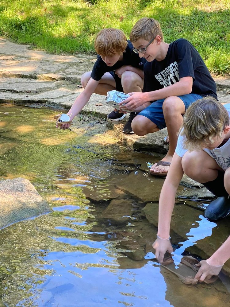 Students learning in the creek