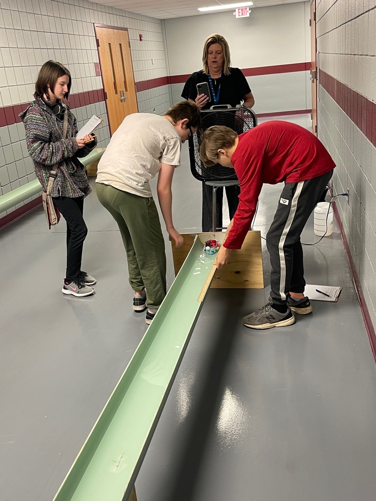 students work on building canoes