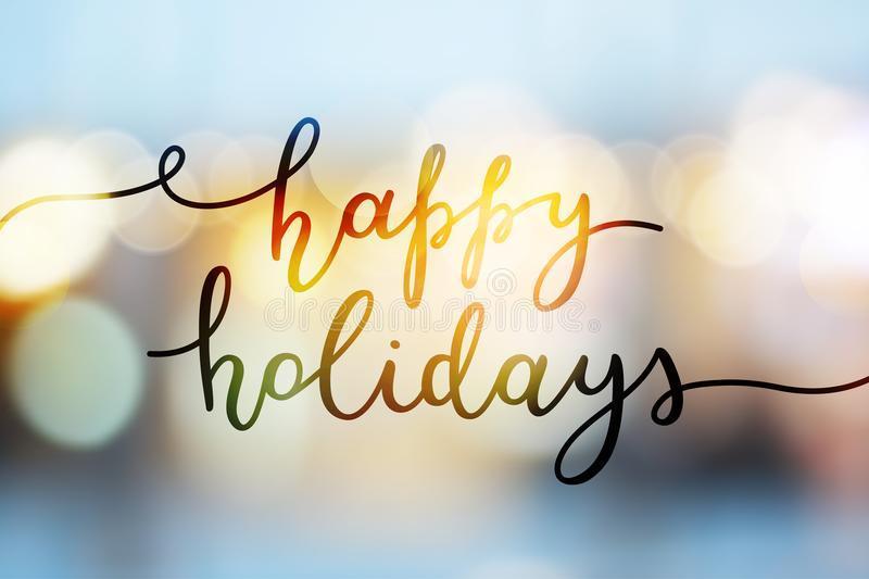 Image that says "happy holidays" in cursive writing, with lights in the background.