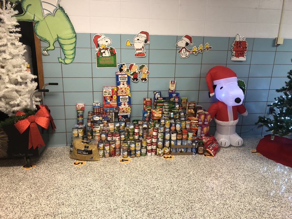 Image of stacked canned goods and non perishable food items donated by students. 