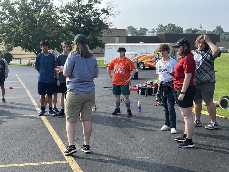 Hildenbrand works with students at band camp
